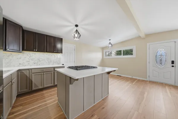a kitchen with granite countertop a sink and a stove top oven