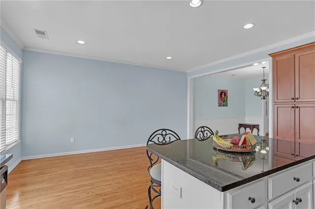 a kitchen with stainless steel appliances granite countertop a sink stove and cabinets