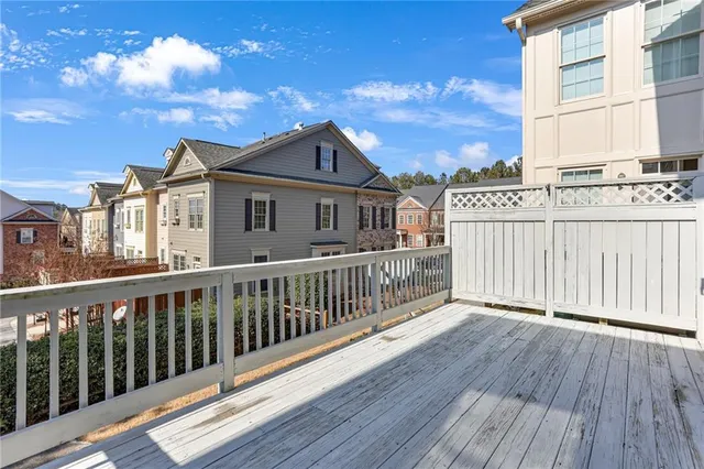 a view of a livingroom with furniture wooden floor a chandelier and a window