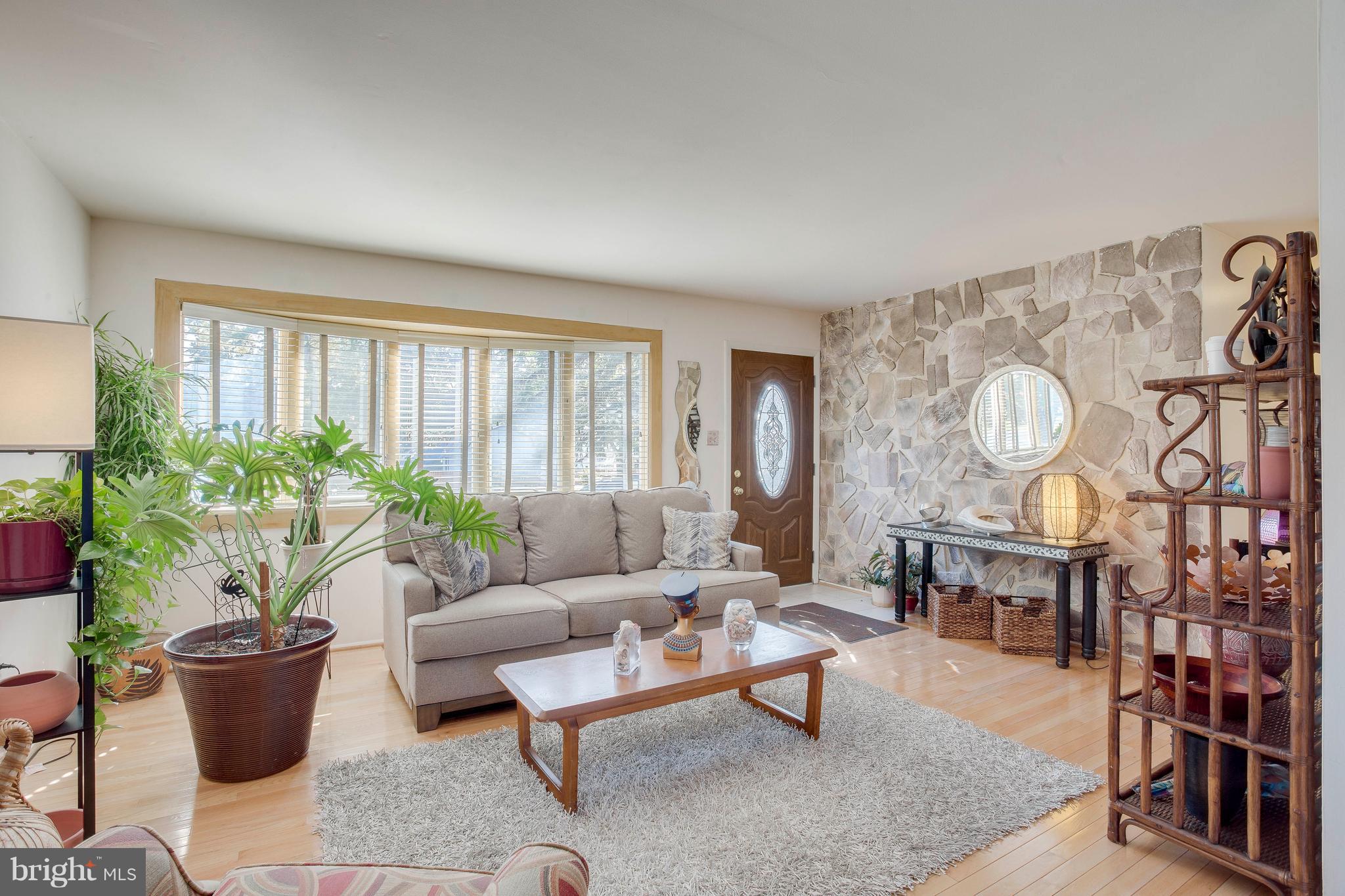 256 Candytuft Road Reisterstown, MD 21136 - Photo 1 of 37 a living room with furniture a lamp and a potted plant