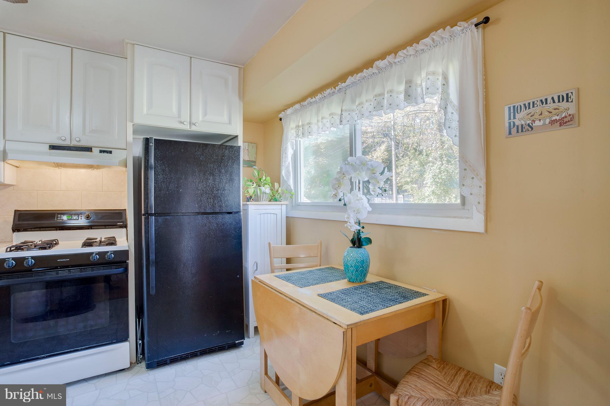 256 Candytuft Road Reisterstown, MD 21136 - Photo 14 of 37 a kitchen with a refrigerator and a stove top oven