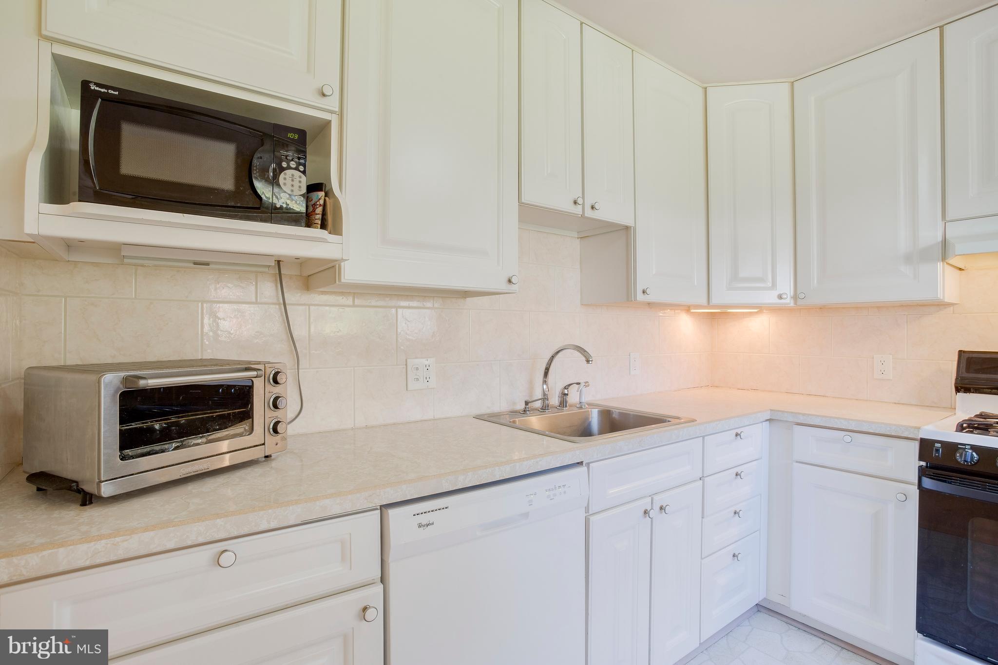 256 Candytuft Road Reisterstown, MD 21136 - Photo 17 of 37 a kitchen with sink cabinets and microwave oven