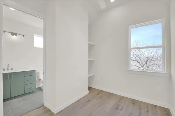 an empty room with windows and closet