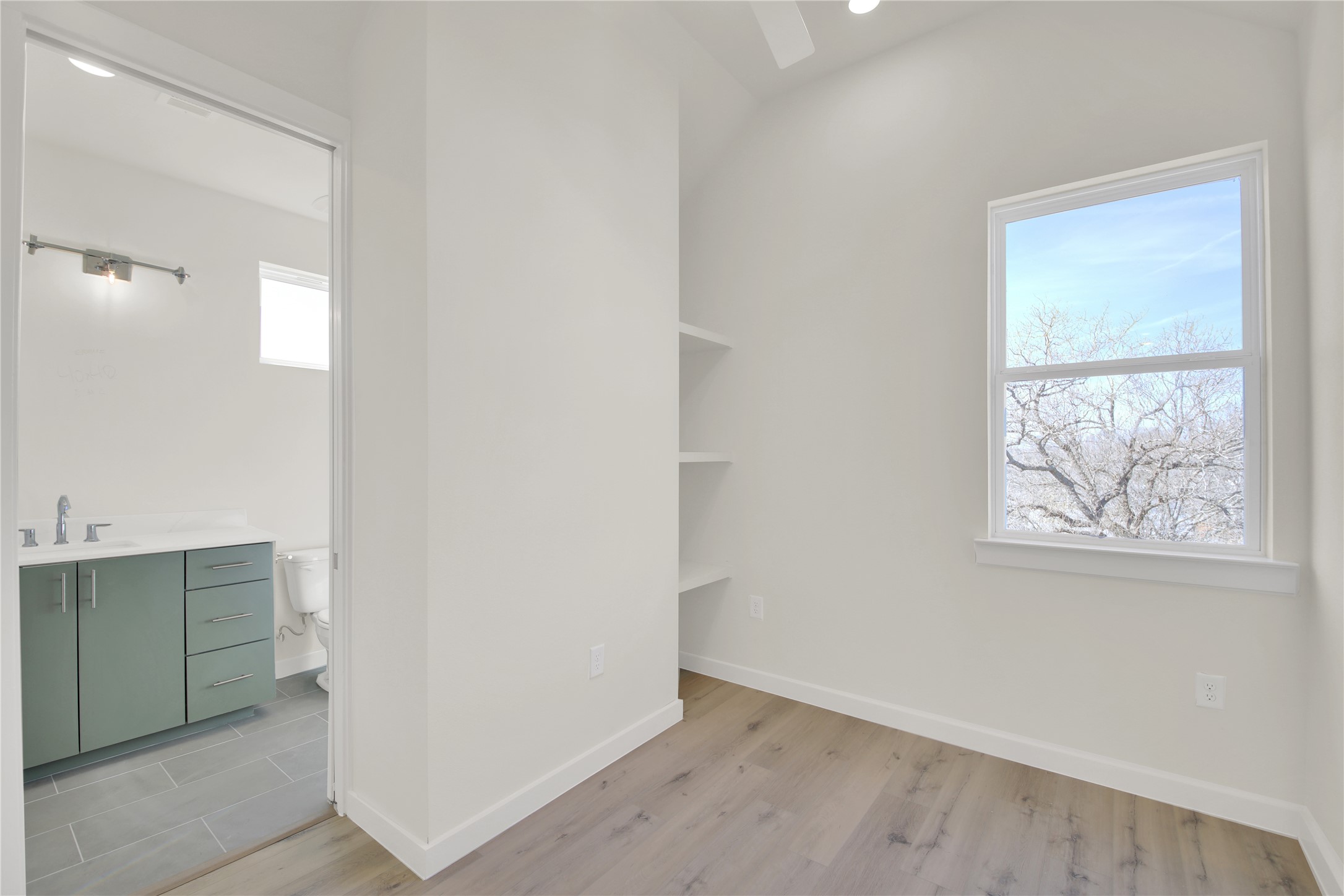 6802 Montana Street, Unit 2 Austin, TX 78741 - Photo 11 of 11 Unfurnished bedroom featuring light wood finished floors and ensuite bath