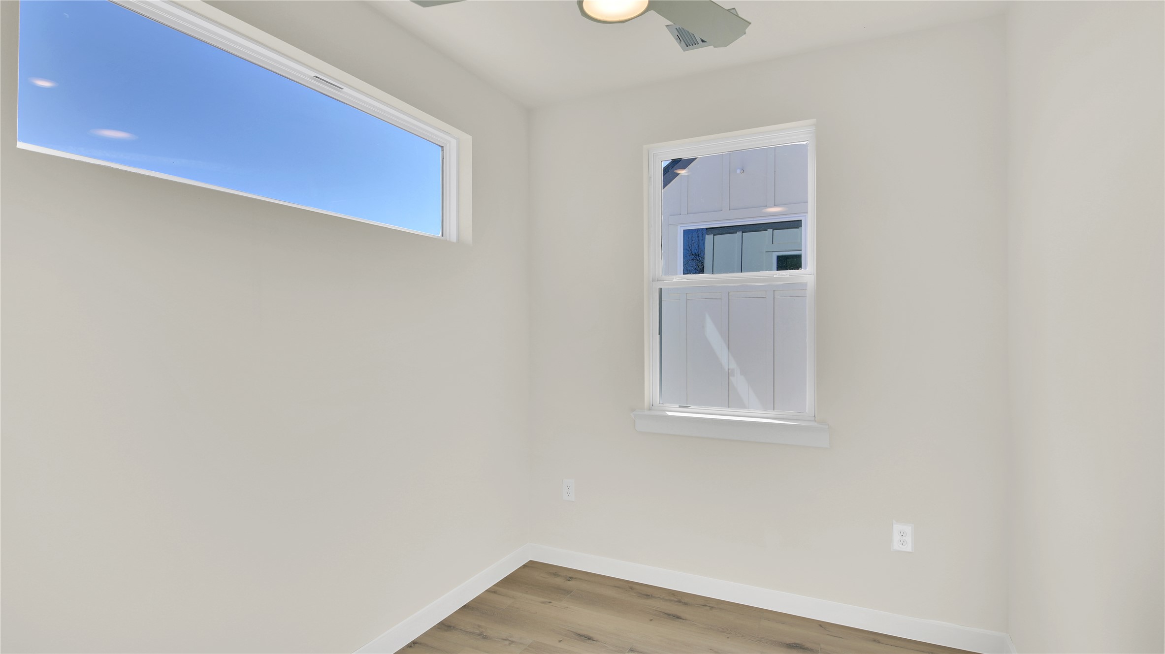 6802 Montana Street, Unit 2 Austin, TX 78741 - Photo 9 of 11 Unfurnished room featuring light wood-style floors and ceiling fan