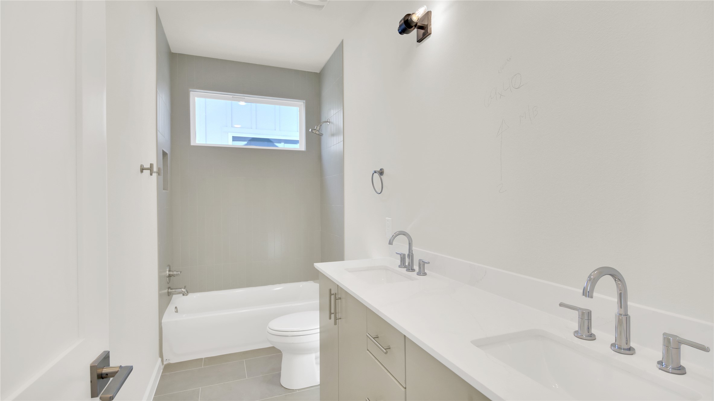 6802 Montana Street, Unit 2 Austin, TX 78741 - Photo 10 of 11 Full bath featuring double vanity, light tile patterned flooring, and shower / bathtub combination