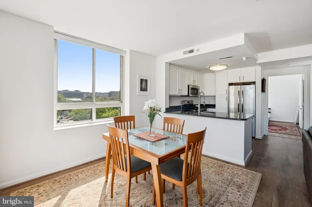 a kitchen with a table and chairs in it