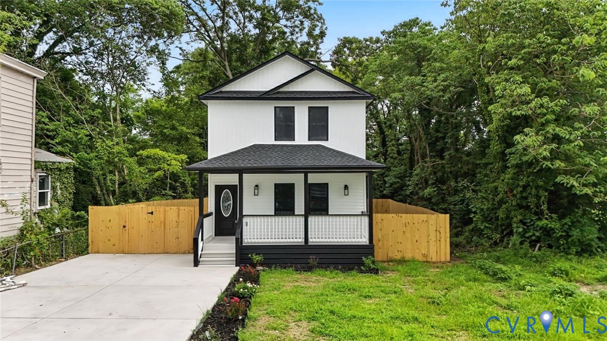 a front view of a house with a yard and trees