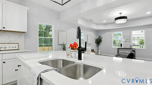 a kitchen with a sink and a large window