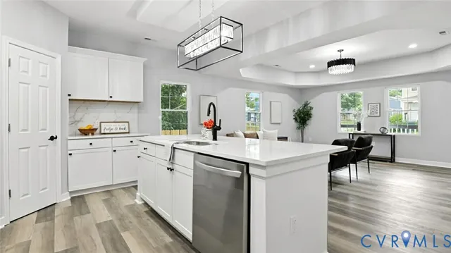a kitchen with cabinets a sink and appliances