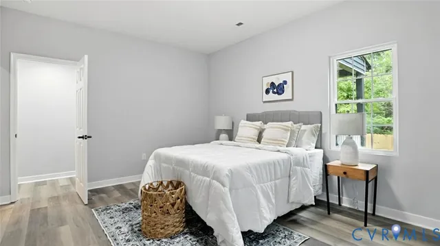 a bedroom with a bed and wooden floor