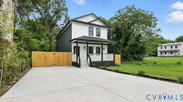 a front view of a house with yard and green space
