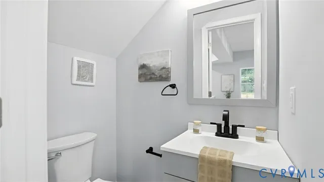 a bathroom with a sink vanity and mirror