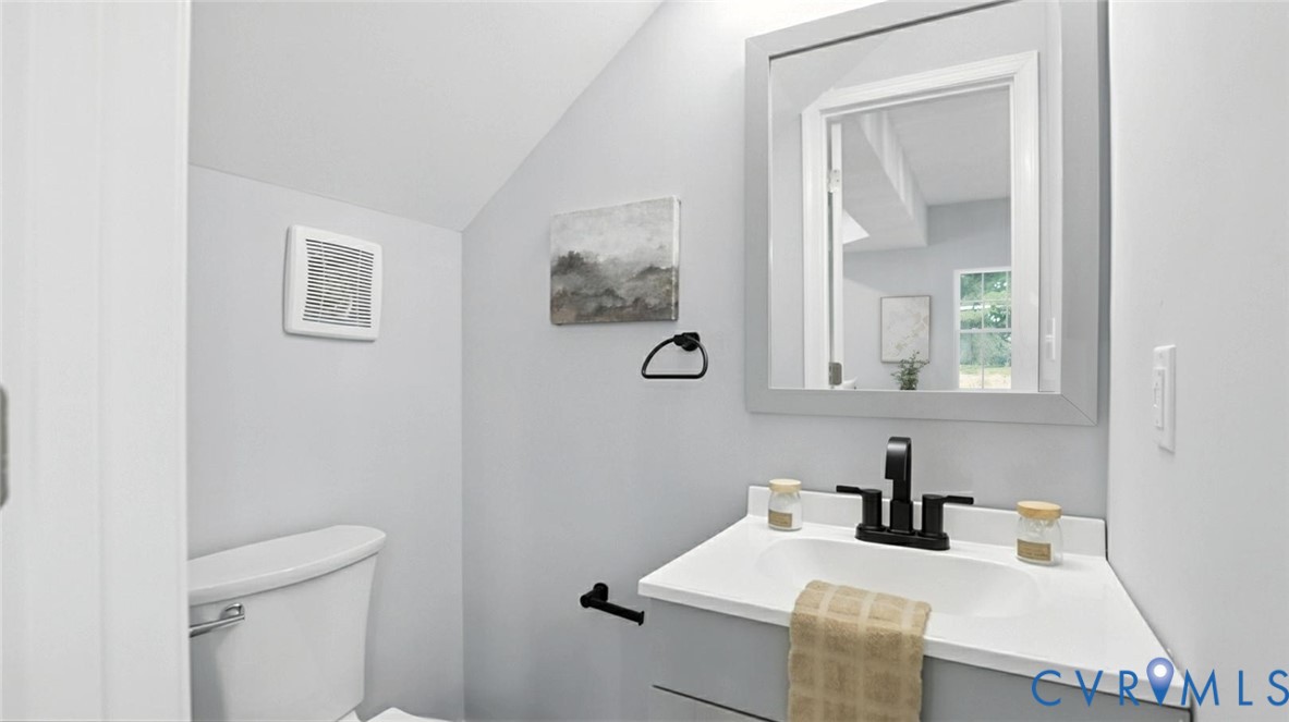 409 Mistletoe Street Petersburg, VA 23803 - Photo 23 of 40 a bathroom with a sink vanity and mirror