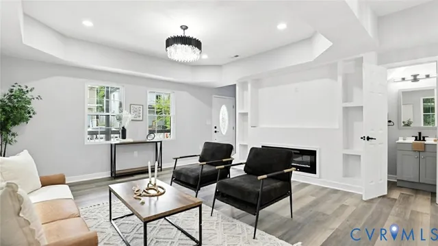 a living room with furniture and a wooden floor