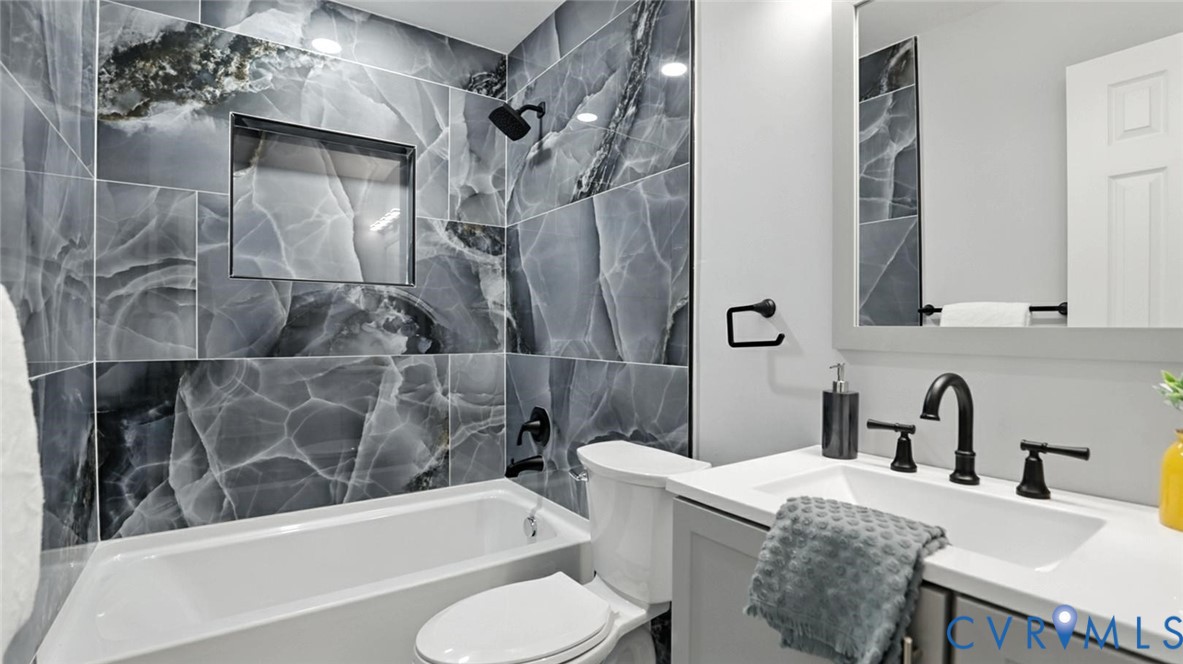 409 Mistletoe Street Petersburg, VA 23803 - Photo 29 of 40 a bathroom with a sink a toilet and bathtub