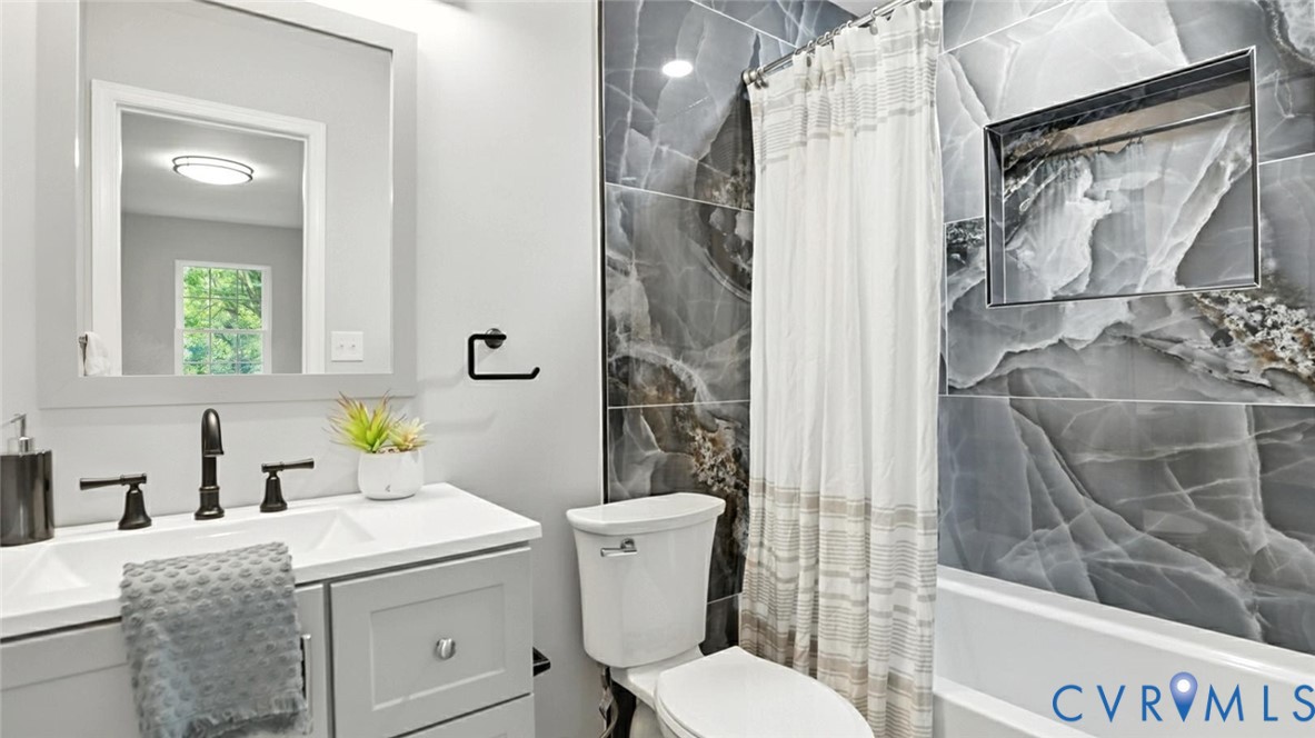 409 Mistletoe Street Petersburg, VA 23803 - Photo 31 of 40 a bathroom with a granite countertop sink toilet and shower