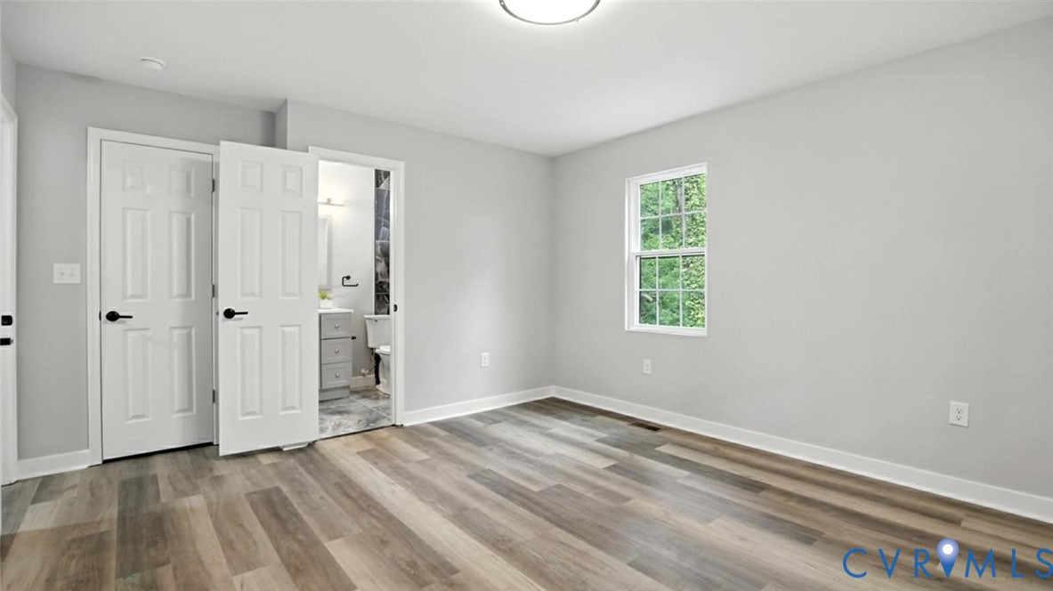 409 Mistletoe Street Petersburg, VA 23803 - Photo 33 of 40 a view of an empty room with wooden floor and a window