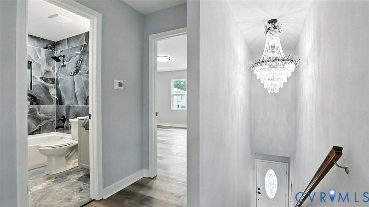 409 Mistletoe Street Petersburg, VA 23803 - Photo 37 of 40 a bathroom with a toilet a sink and shower