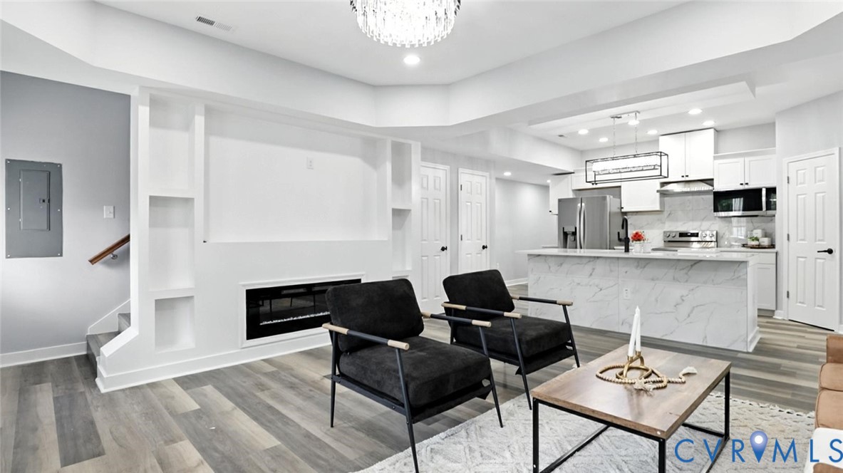 409 Mistletoe Street Petersburg, VA 23803 - Photo 7 of 40 a living room with fireplace furniture and a hard wood floor