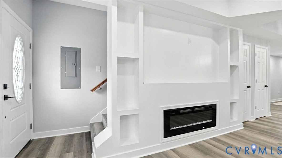 409 Mistletoe Street Petersburg, VA 23803 - Photo 9 of 40 a view of a livingroom with wooden floor and a fireplace