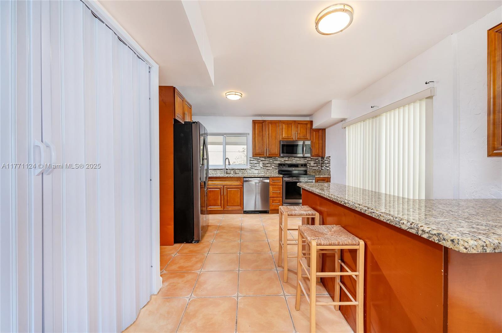 1007 Northwest 106th Ave Circle Miami, FL 33172 - Photo 11 of 41 a kitchen with stainless steel appliances granite countertop a refrigerator and a sink