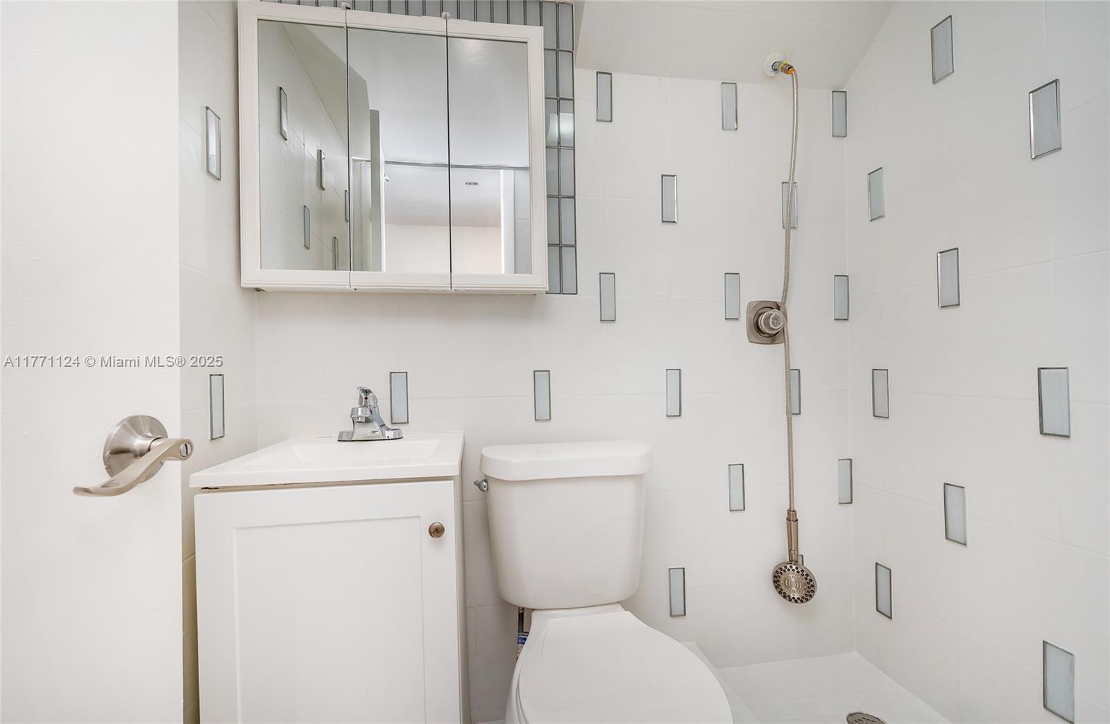 1007 Northwest 106th Ave Circle Miami, FL 33172 - Photo 20 of 41 a bathroom with a toilet sink and shower