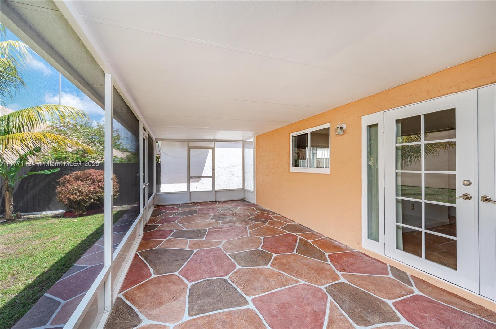 1007 Northwest 106th Ave Circle Miami, FL 33172 - Photo 22 of 41 a view of an empty room with a yard and a floor to ceiling window