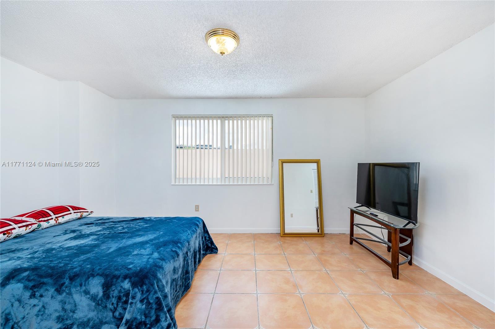 1007 Northwest 106th Ave Circle Miami, FL 33172 - Photo 26 of 41 a bedroom with a bed and a tv