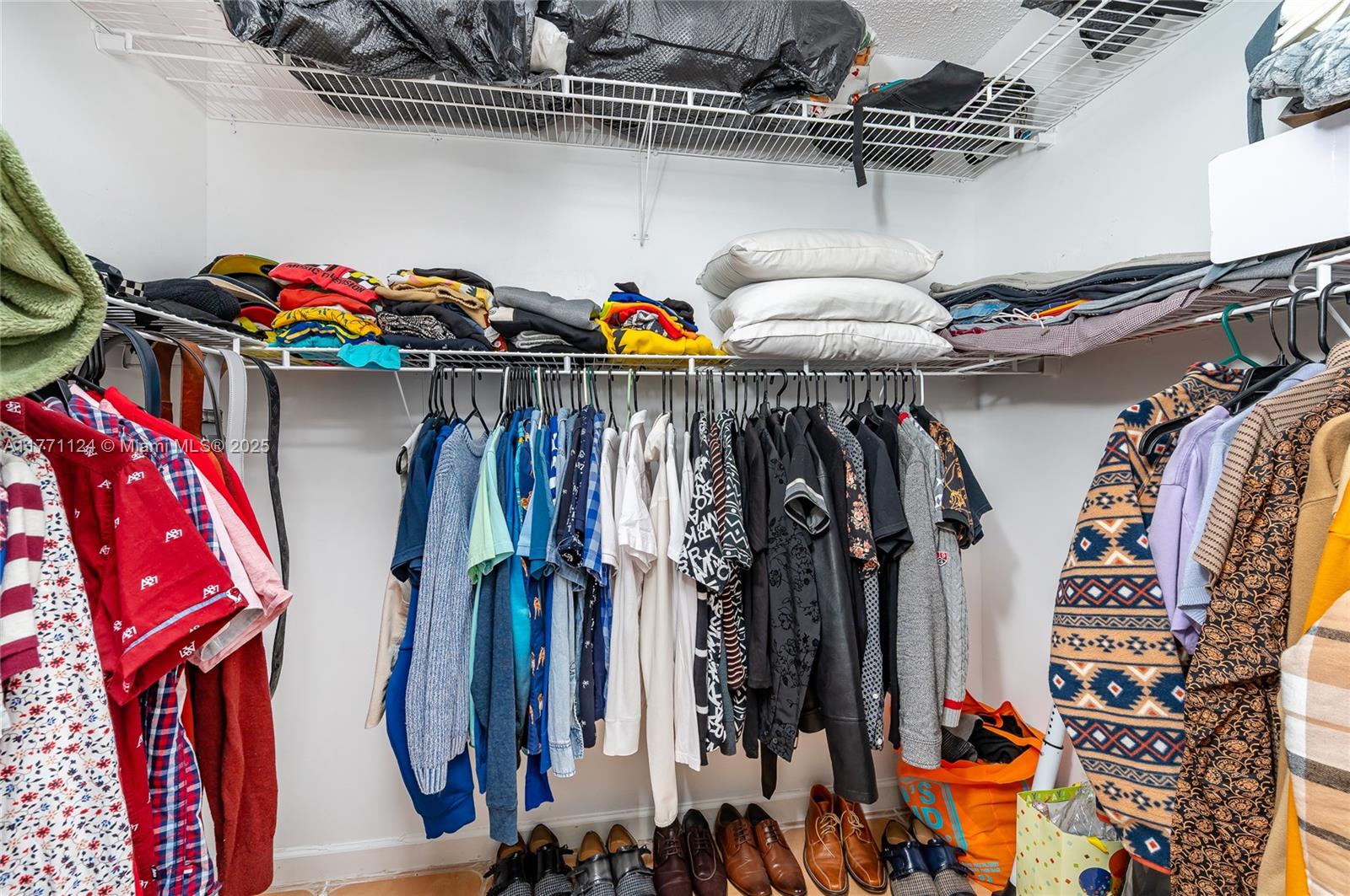 1007 Northwest 106th Ave Circle Miami, FL 33172 - Photo 27 of 41 a view of walk in closet with clothes and shoes