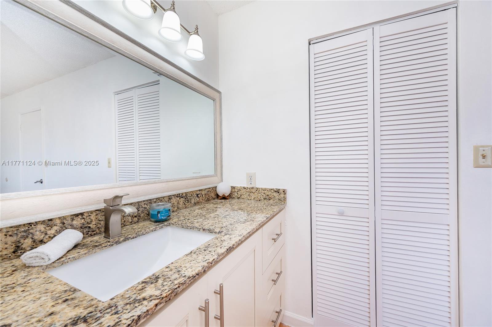 1007 Northwest 106th Ave Circle Miami, FL 33172 - Photo 31 of 41 a bathroom with a granite countertop sink and a bathtub