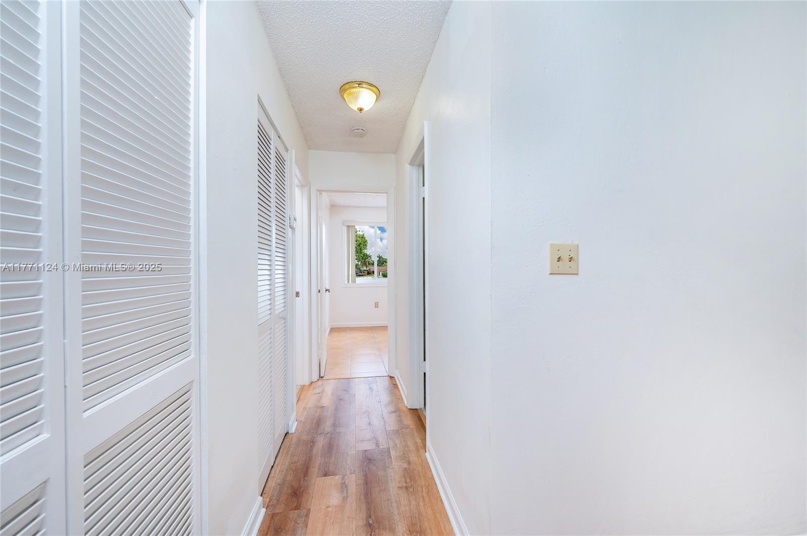 1007 Northwest 106th Ave Circle Miami, FL 33172 - Photo 32 of 41 a view of a hallway with wooden floor