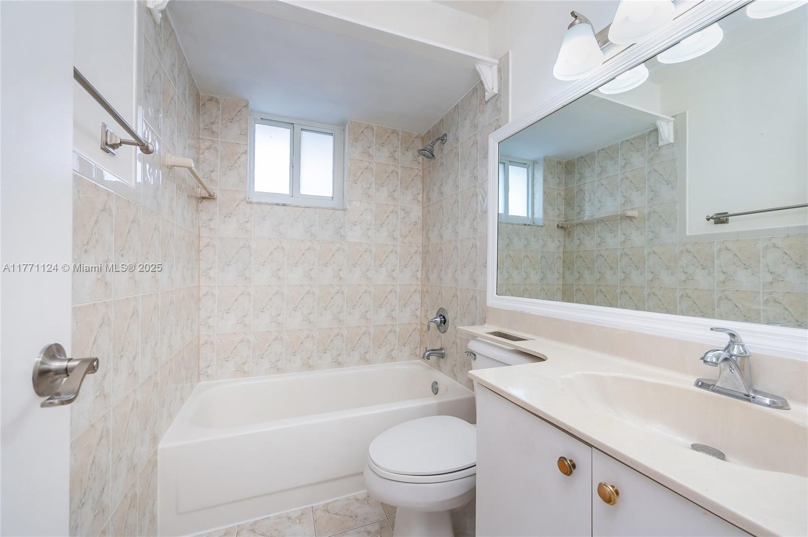 1007 Northwest 106th Ave Circle Miami, FL 33172 - Photo 33 of 41 a bathroom with a sink a toilet and a bathtub