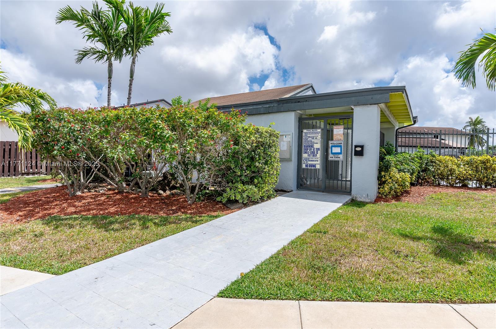 1007 Northwest 106th Ave Circle Miami, FL 33172 - Photo 38 of 41 a view of a house with a small yard and potted plants