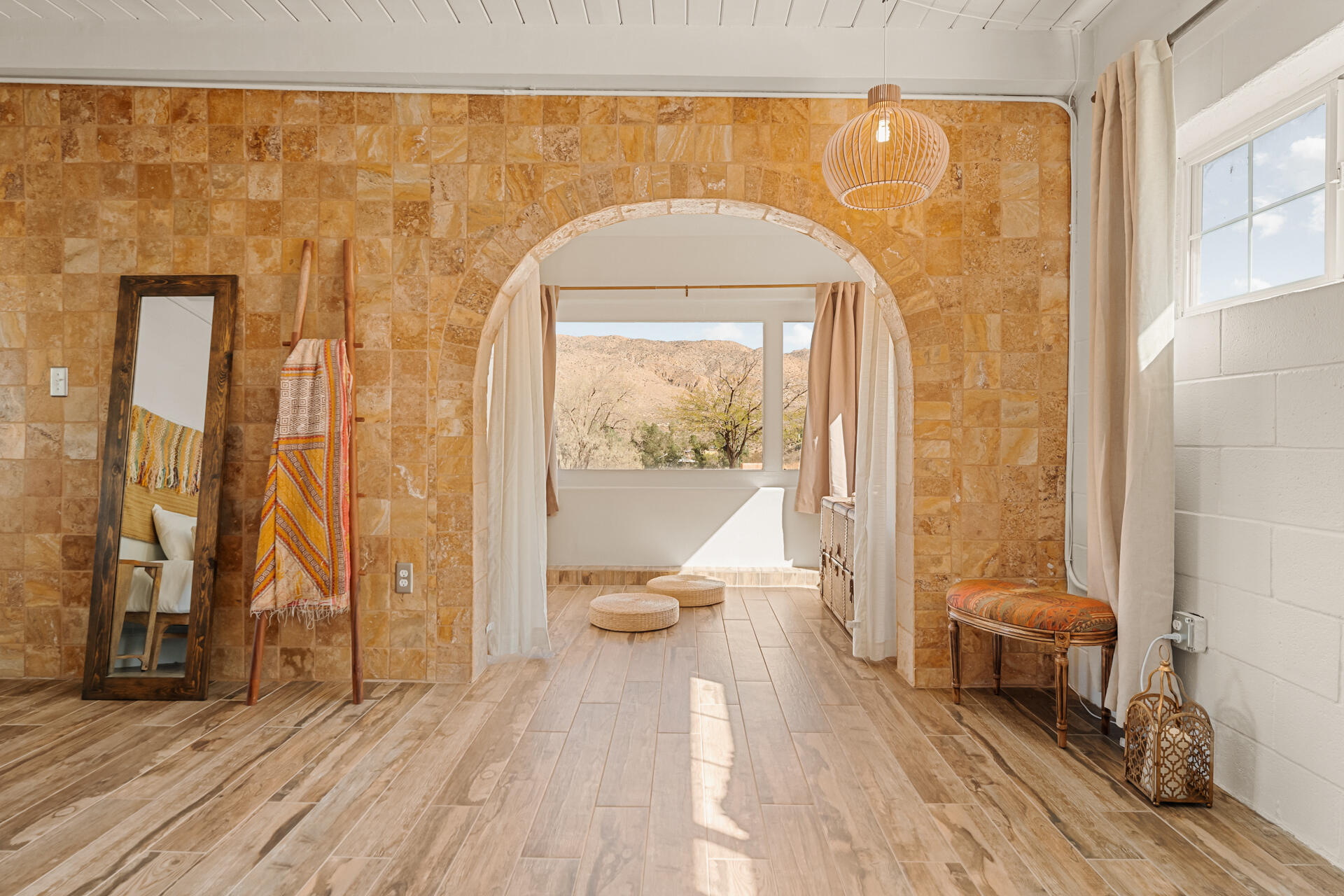 53019 Apache Trail Morongo Valley, CA 92256 - Photo 17 of 37 a living room with a fireplace and a floor to ceiling window