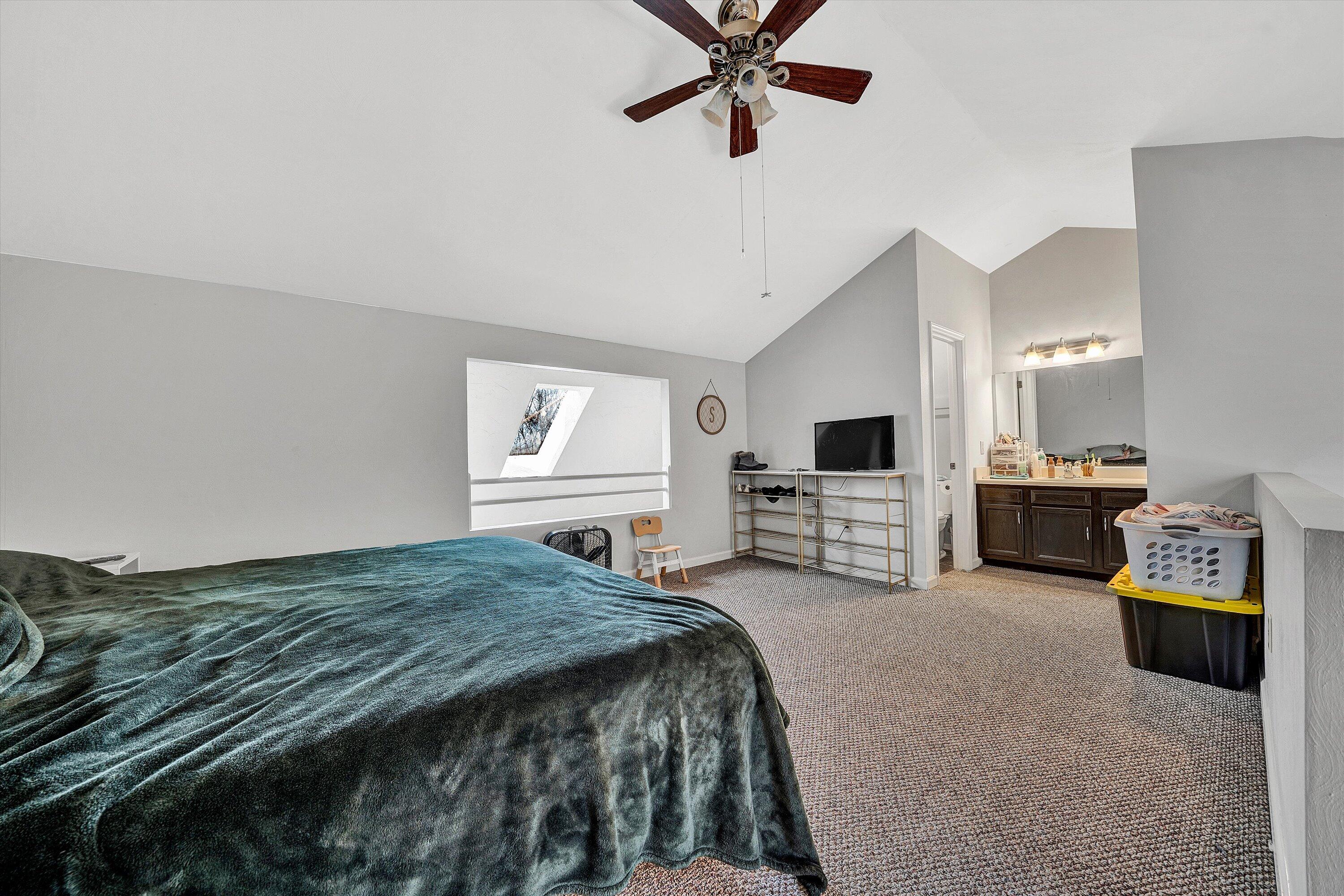 3309 Forest Ridge Road Roanoke, VA 24018 - Photo 13 of 18 a spacious bedroom with a bed a couch and a chandelier