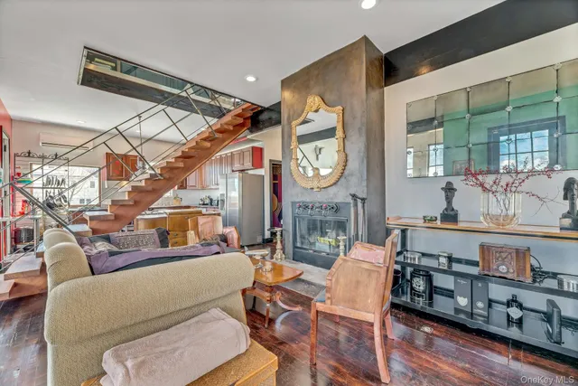 a living room with furniture a clock and a large window