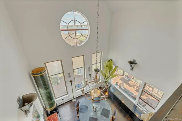 an entryway with wooden floor and mirror