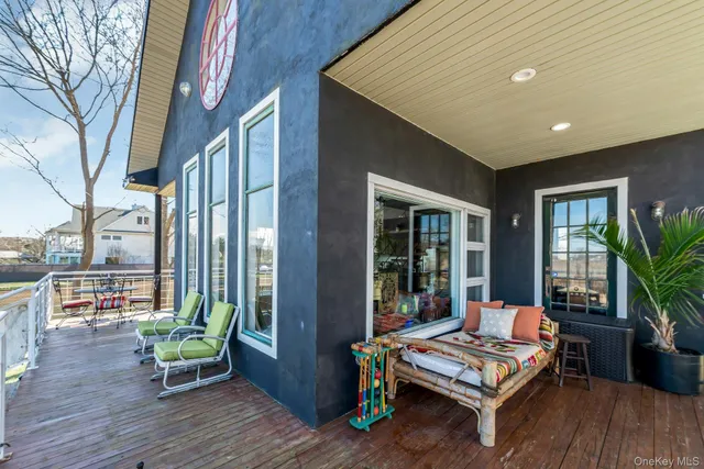 a balcony with furniture and wooden floor