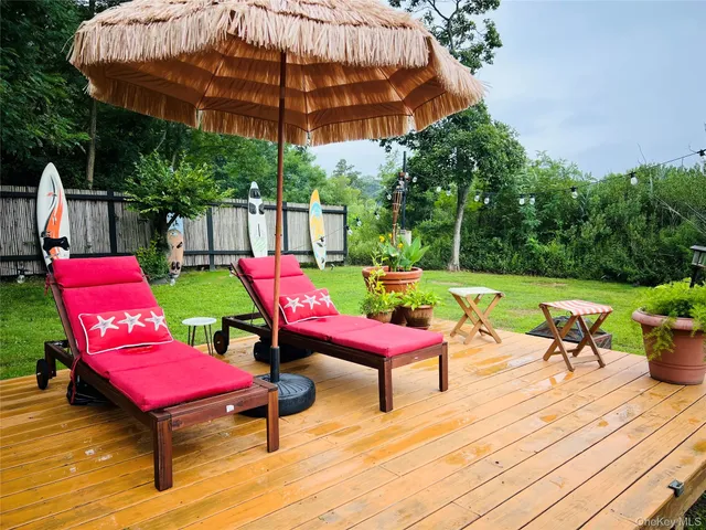 a swimming pool with lawn chairs and umbrella