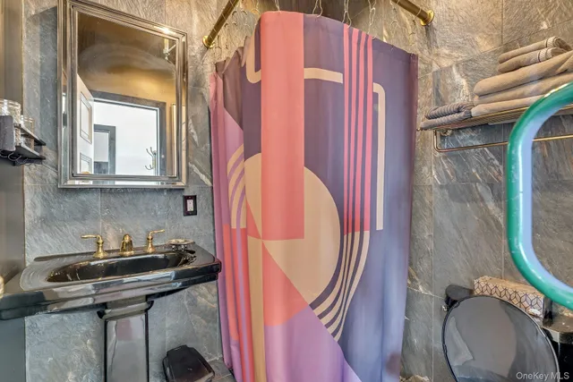 a bathroom with a sink a toilet and a mirror