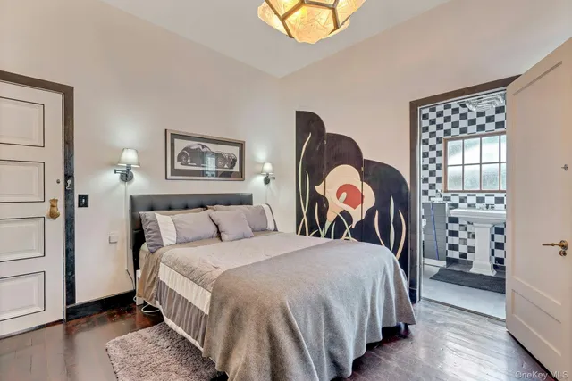 a bedroom with bed and wooden floor