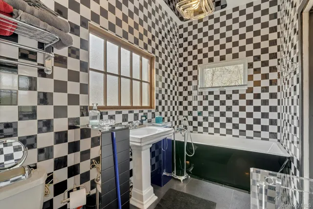 a bathroom with a sink a toilet and a shower