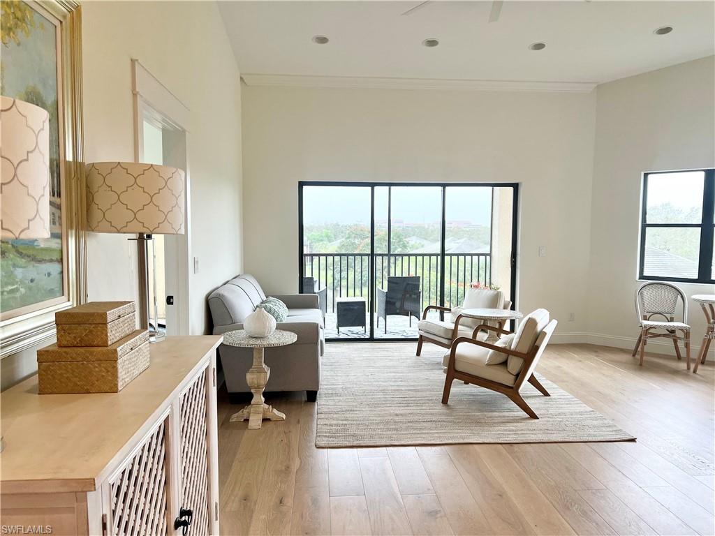 195 Vintage Circle, Unit E403 Naples, FL 34119 - Photo 11 of 39 a living room with furniture and a large window