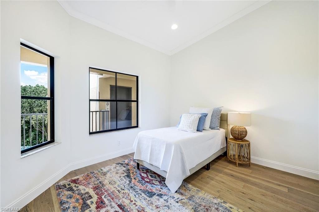 195 Vintage Circle, Unit E403 Naples, FL 34119 - Photo 25 of 39 a bedroom with a bed and a window