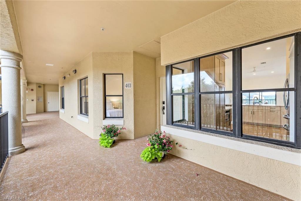 195 Vintage Circle, Unit E403 Naples, FL 34119 - Photo 28 of 39 a view of entrance with wooden floor and windows