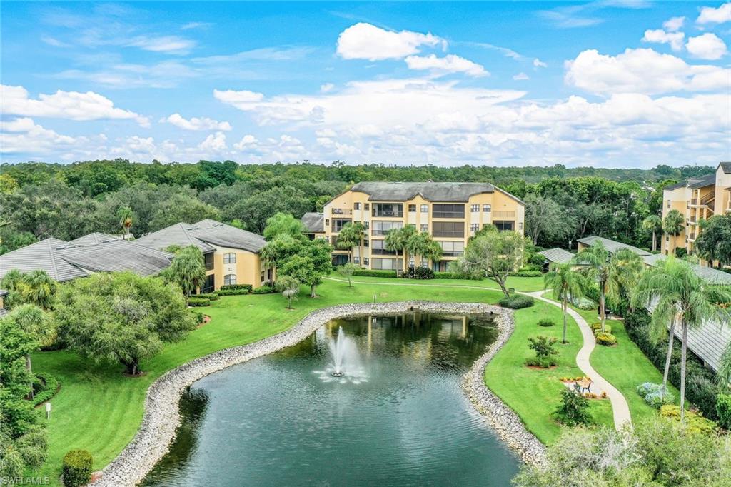 195 Vintage Circle, Unit E403 Naples, FL 34119 - Photo 32 of 39 a view of a lake with a garden