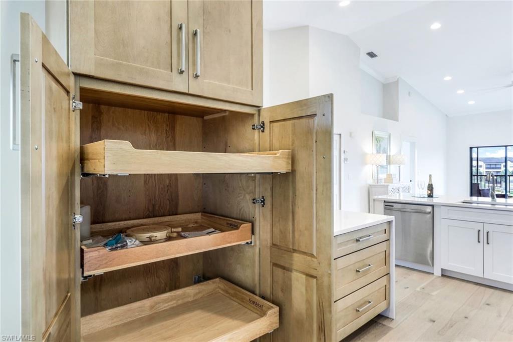 195 Vintage Circle, Unit E403 Naples, FL 34119 - Photo 7 of 39 a kitchen with a stove and a refrigerator