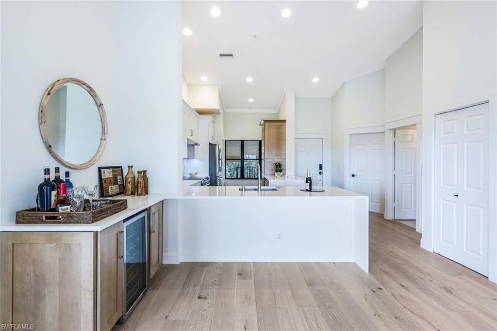 195 Vintage Circle, Unit E403 Naples, FL 34119 - Photo 10 of 39 a view of kitchen with stainless steel appliances granite countertop a stove and a wooden floors