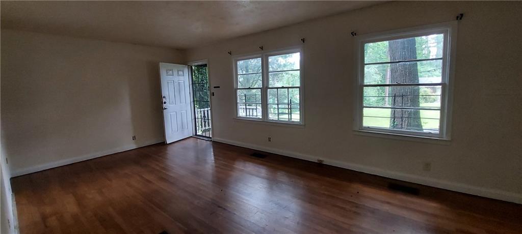 2980 Wanda Circle Southwest Atlanta, GA 30315 - Photo 7 of 11 a view of an empty room with wooden floor and a window